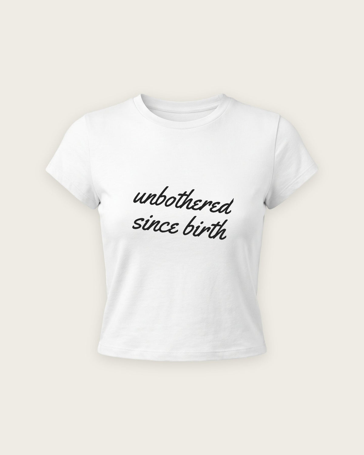 Baby Tee “Unbothered Since Birth” — Branco